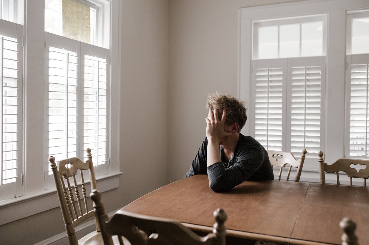 zipwp-image-3132388 Photo of Man Leaning on Wooden Table